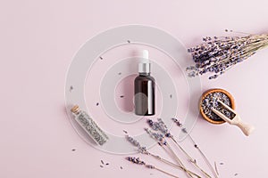 bottle with pipette dispenser with natural lavender oil or personal care serum. concept aromatherapy, spawning. top view