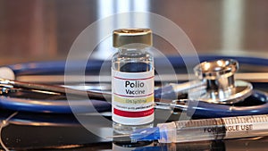 Vial of Polio Vaccine on a stainless steel background photo