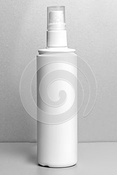 bottle with pulvilizer for drugs, antiseptics, liquids on a gray background