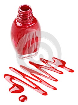 Bottle of red nail polish with enamel drop samples