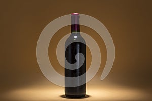 Bottle of red wine on a brown background, warmth