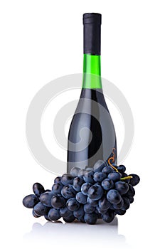 Bottle of red wine with bunch of grapes isolated