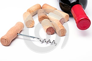 Bottle of red wine, corks and corkscrew