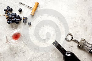 Bottle of red wine and corkscrew on stone background top view mockup