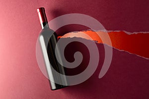 Bottle of red wine on a dark red background