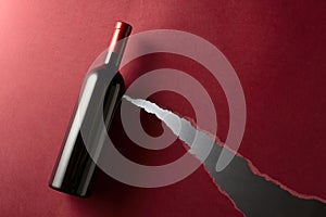 Bottle of red wine on a dark red background