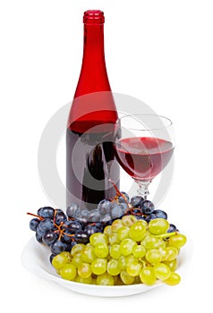 Bottle of red wine, glass and grapes
