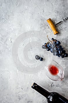 Bottle of red wine with glass on texture background top view mock-up