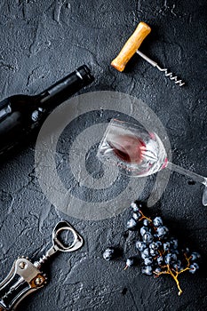 Bottle of red wine with glasses on texture background top view