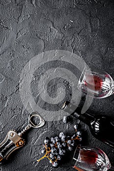 Bottle of red wine with glasses on texture background top view mock-up