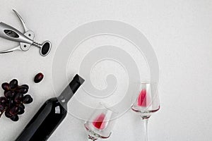 Bottle of red wine with glasses on white background top view mock-up