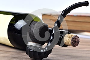 bottle of red wine with pipe and old book