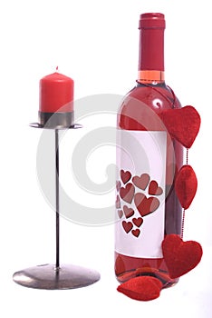 Bottle of red wine with red candle photo