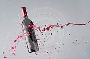 Bottle of red wine and splashes