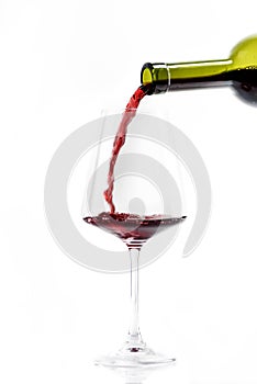 Bottle of red wine and wineglass isolated on white background. Luxury french wine pouring in glass. Wine splashing concept. Winery