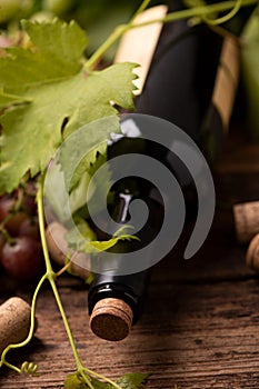 Bottle of red wine on wooden table