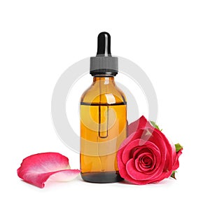 Bottle of rose essential oil and flower