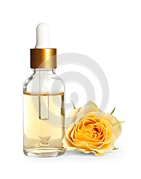 Bottle of rose essential oil and flower