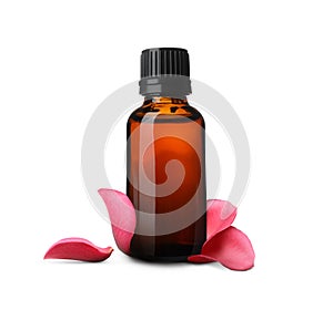 Bottle of rose essential oil and flower petals on white background