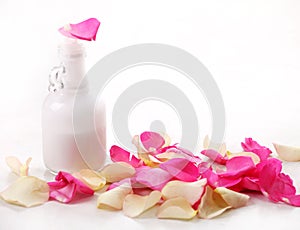 Bottle and rose petals