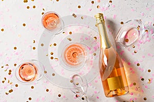 Bottle of rose sparkling wine on grey background