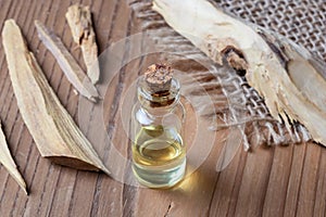 A bottle of sandalwood essential oil with white sandalwood