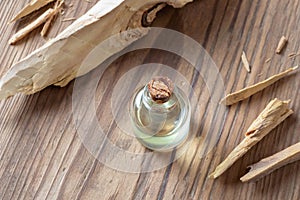 A bottle of sandalwood essential oil with white sandalwood