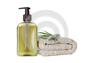 Bottle of shampoo and terry towel on white background