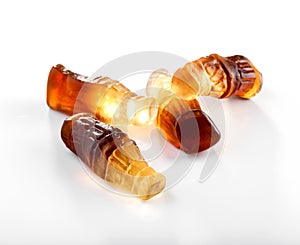Bottle shaped gummies with cola  flavor close-up on white background