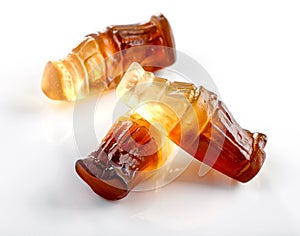 Bottle shaped gummies with cola  flavor close-up on white background