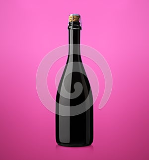 Bottle of sparkling wine with cork on a colored background