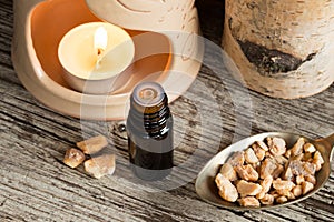 A bottle of styrax benzoin essential oil with benzoin resin and