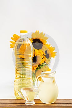 Bottle of sunflower oil with flower isolated on white background