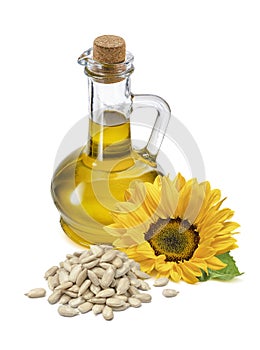 Bottle of sunflower oil, flower and shelled seeds isolated on white background