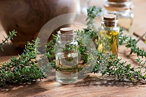 A bottle of thyme essential oil with fresh thyme twigs