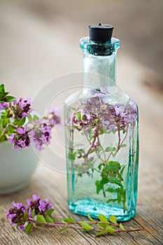 Bottle of thyme infusion and mortar.