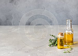Bottle of thyme thymus essential oil with fresh thyme.