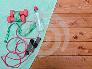 Bottle with towel, dumbbells and skipping rope