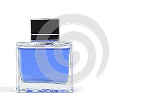 Bottle with transparent glass with blue perfume inside white background.