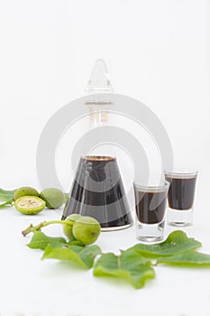 Bottle and two glasses with walnut liquor