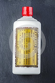 Bottle of typical strong chinese liquer isolated on stone slate stone background.