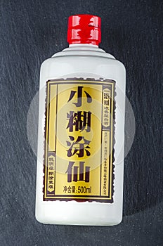 Bottle of typical strong chinese liquer isolated on stone slate stone background.