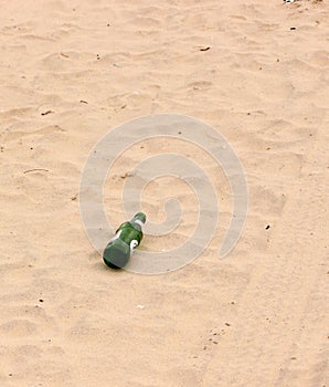 Bottle, tyre tracks in sand