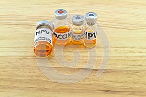 Bottle vaccine of Human papillomavirus HPV vaccine on wooden background