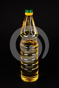 Bottle vegetable oil on black background