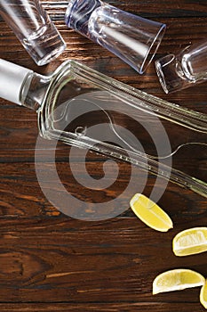 Bottle vodka on wooden table with copy space. View from above, top view