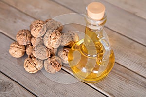 A bottle of walnut oil and a pile of walnuts