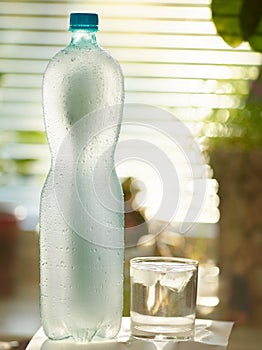 Bottle with water covered with drops