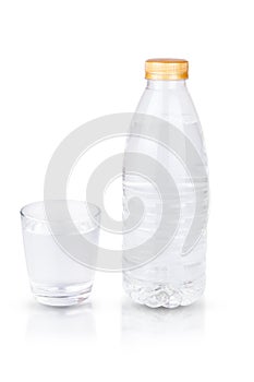Bottle of water and empty glass isolated on white background