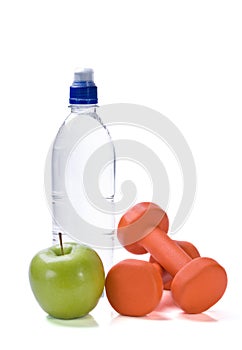 Bottle of water with fitness weights and apple